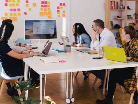 A team in an office discussing sales enablement during a meeting